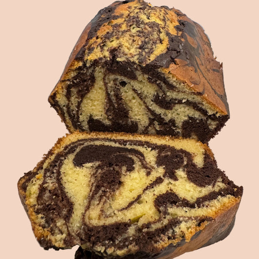 Marble cake with chocolate and vanilla swirled layers on a white plate.