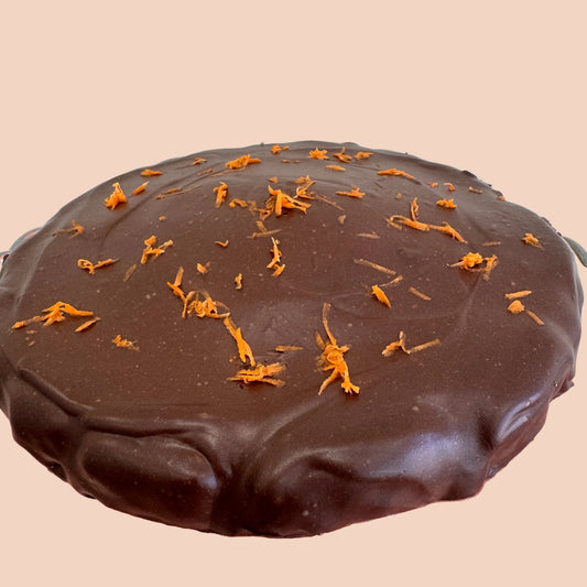 Chocolate carrot cake with carrot zest on a decorative glass plate
