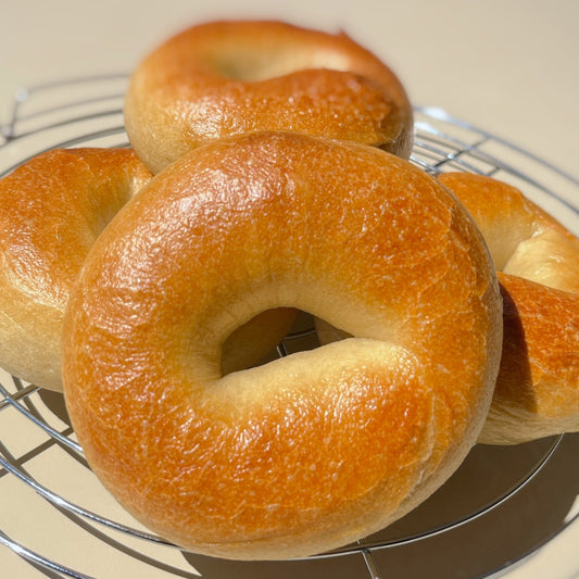 Golden-brown plain bagels ready to be enjoyed at cafeAtaraxia in Parede. The best bagels in Portugal.